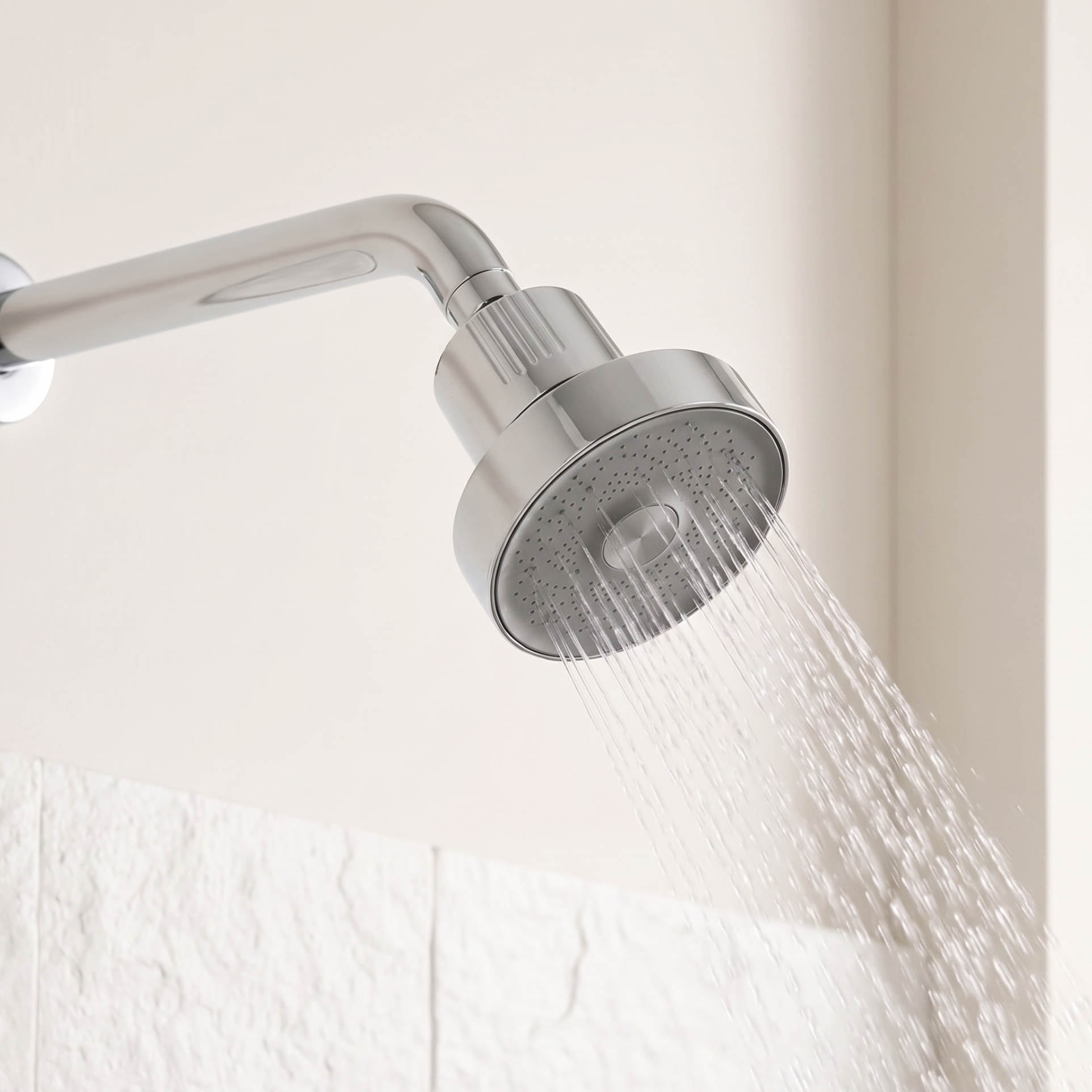 PorePlus showerhead installed and running in a white tiled shower